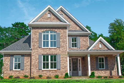 brick house with gray shutters.